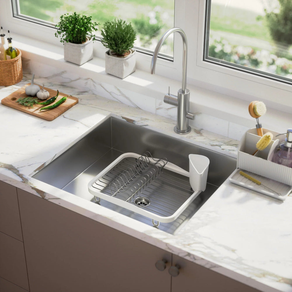 Modern kitchen sink with a window view and kitchen utensils.