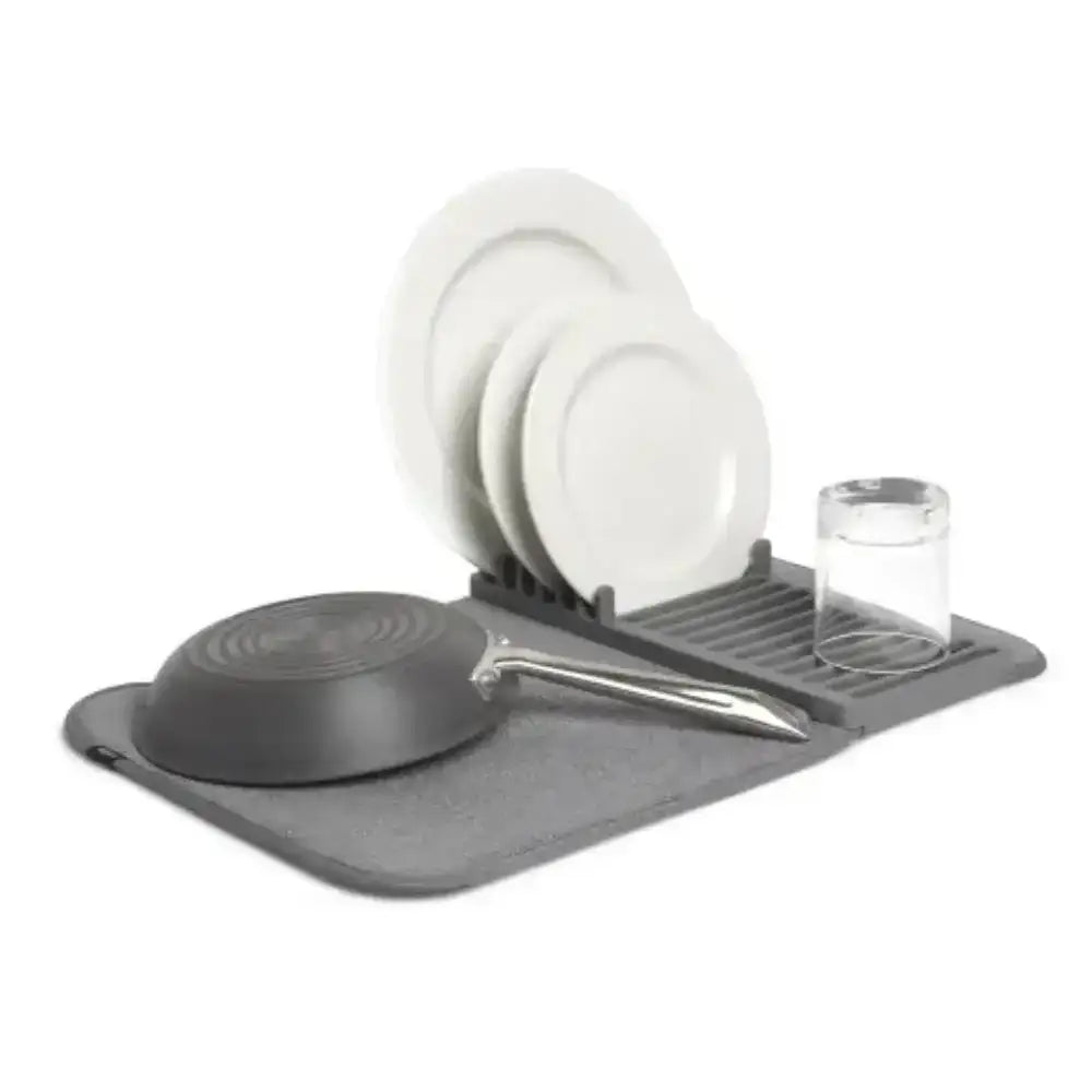 Gray dish drying rack with plates, bowls, and a frying pan on a white background