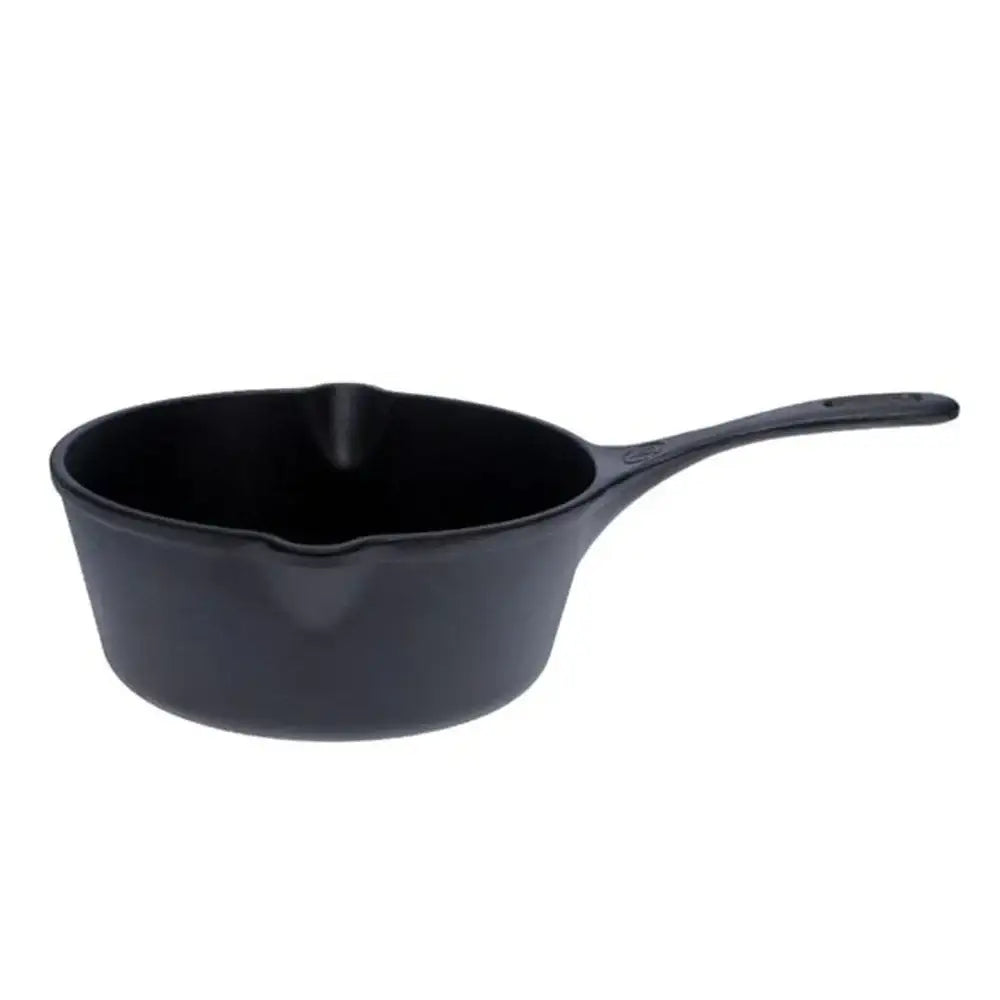 Black cast iron skillet on a white background