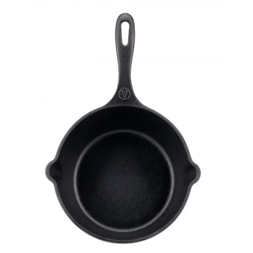 Black cast iron skillet on a white background