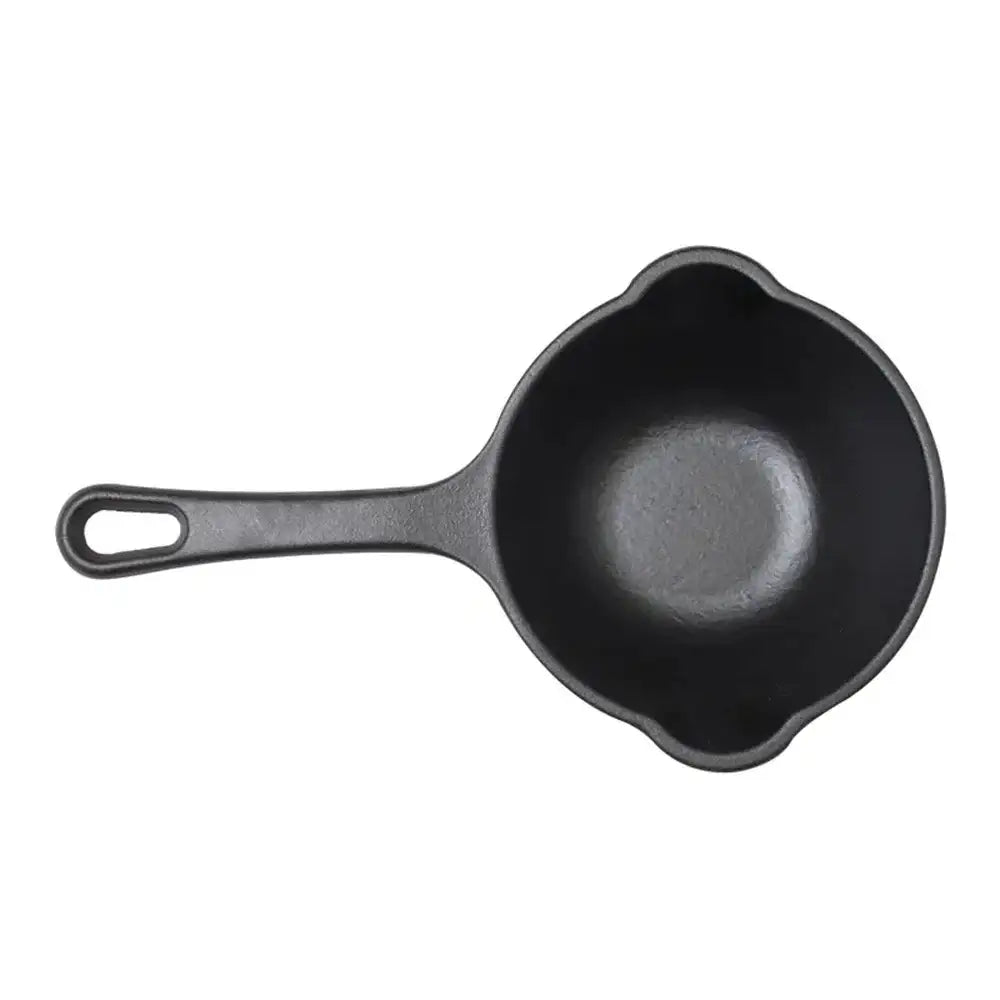 Black cast iron skillet on a white background