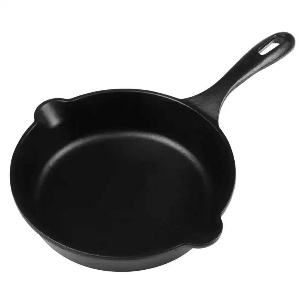Black cast iron skillet on a white background