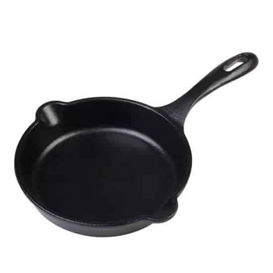 Black cast iron skillet on a white background