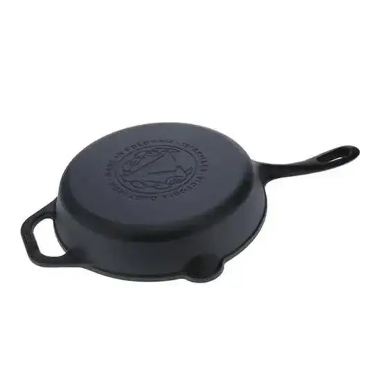 Black cast iron skillet with handle on a white background
