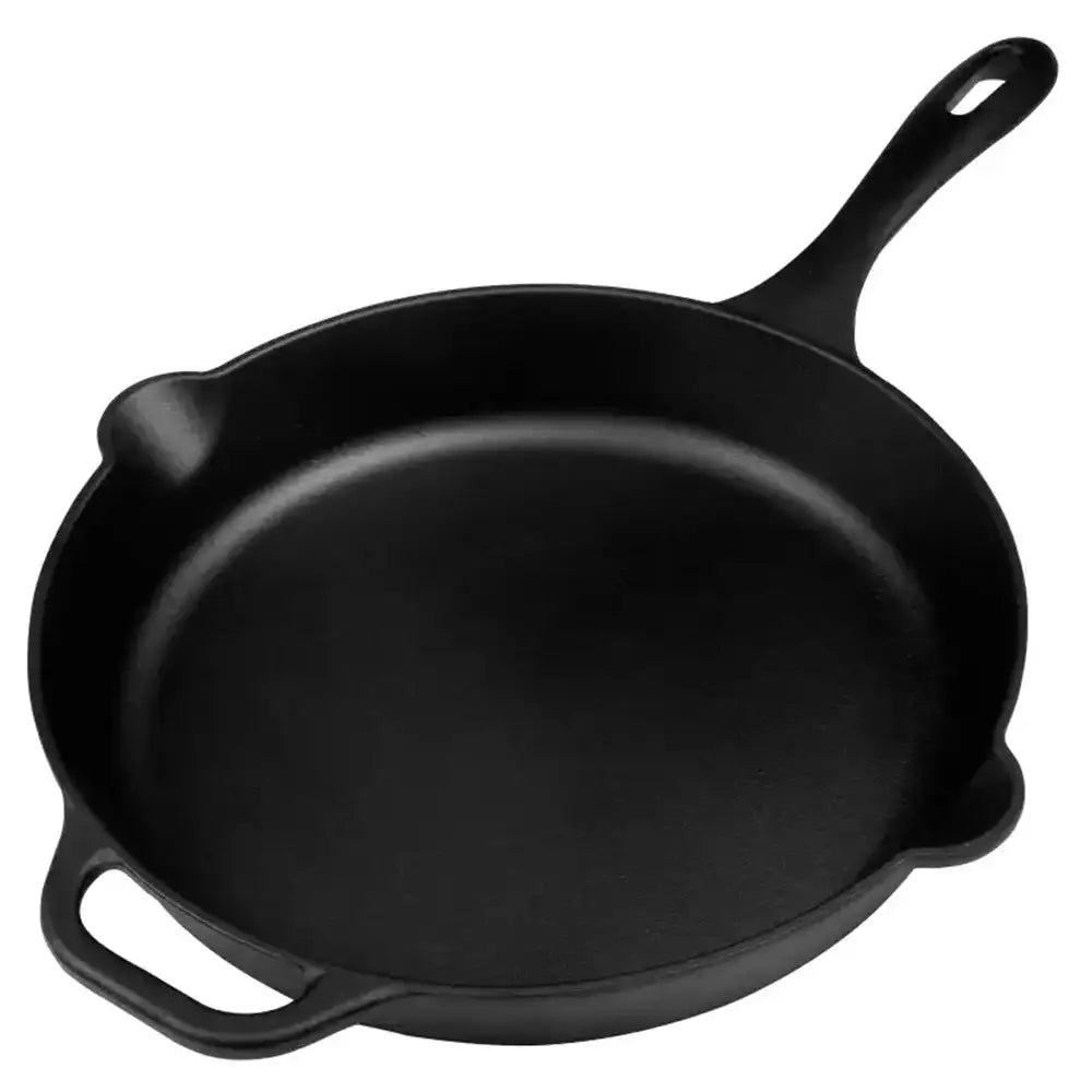 Black cast iron skillet on a white background