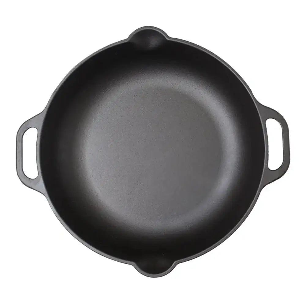 Black cast iron skillet on a white background