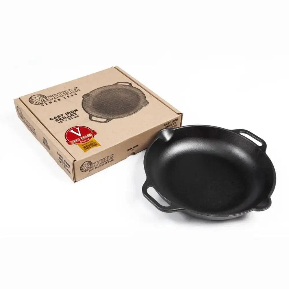 Black cast iron skillet with box on a white background