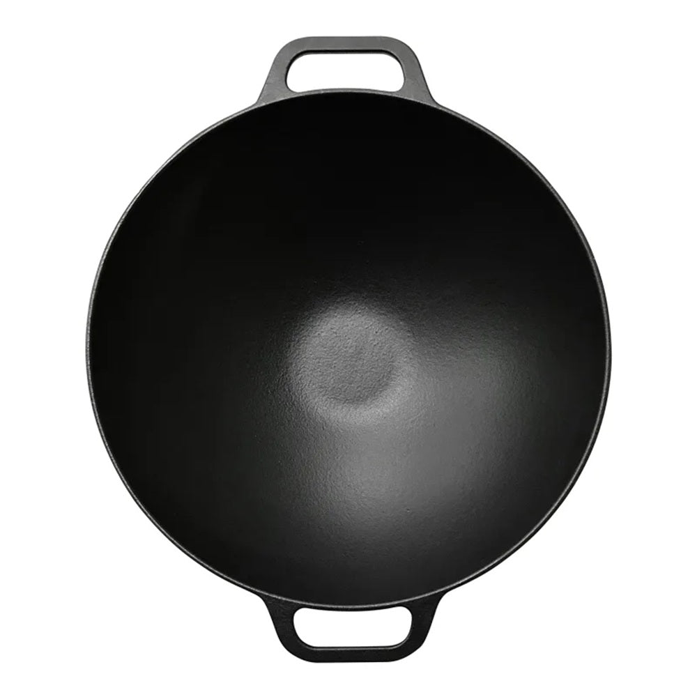 Black cast iron wok on a white background