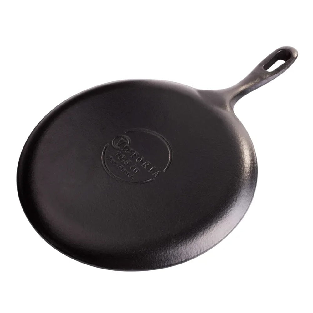Black cast iron skillet with a handle on a white background