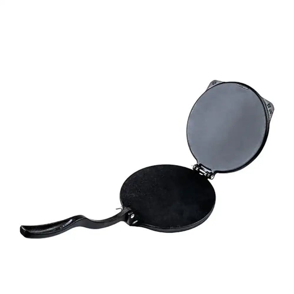 Black cast iron crepe maker on a white background