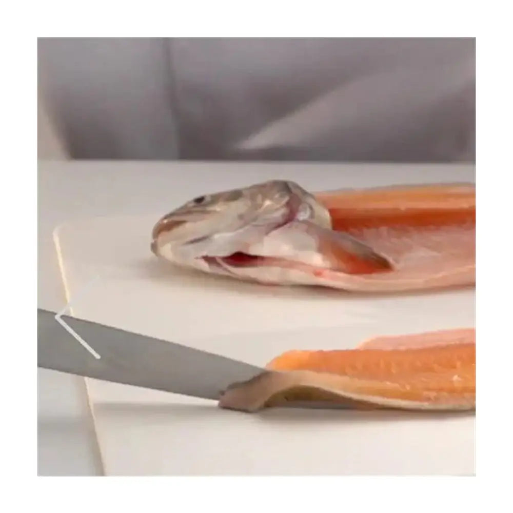 Raw fish fillet on a cutting board with a knife