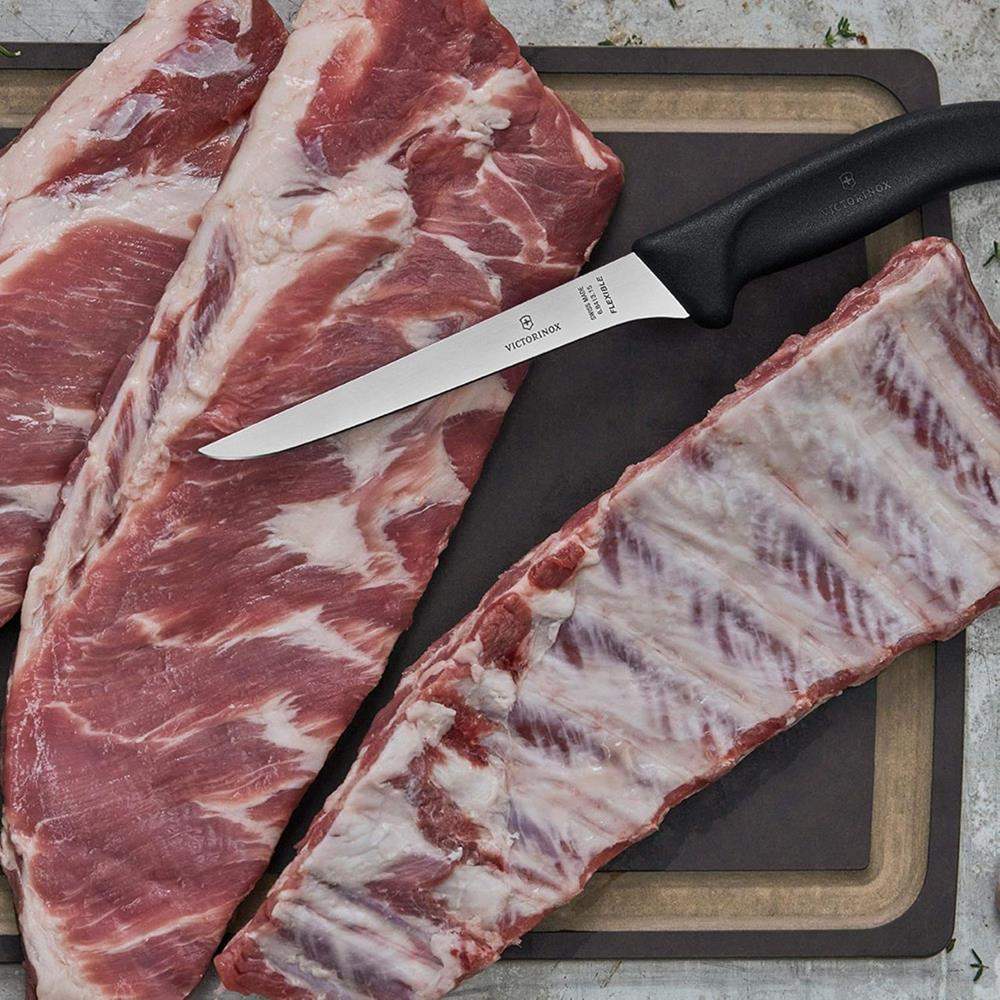 Raw meat with a knife on a cutting board