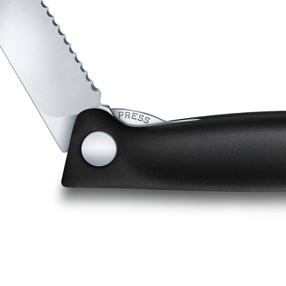 Close-up of a knife with a serrated blade and black handle on a white background