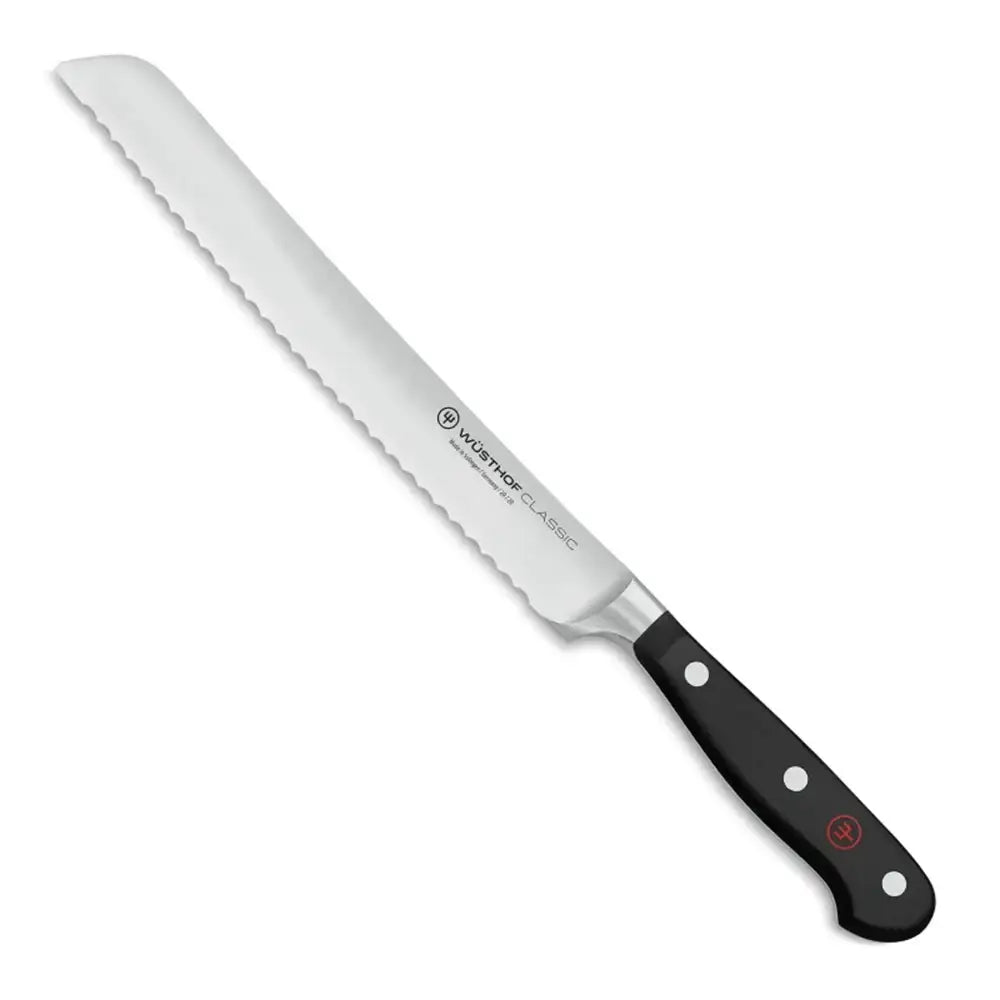 Bread knife with black handle on a white background