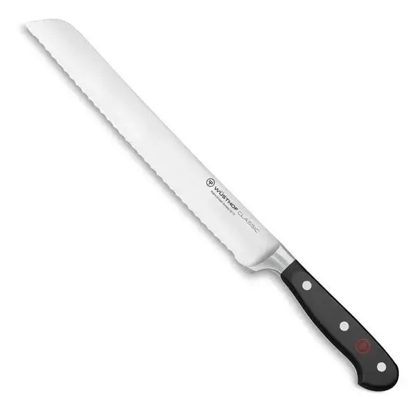 Bread knife with a white blade and black handle on a white background
