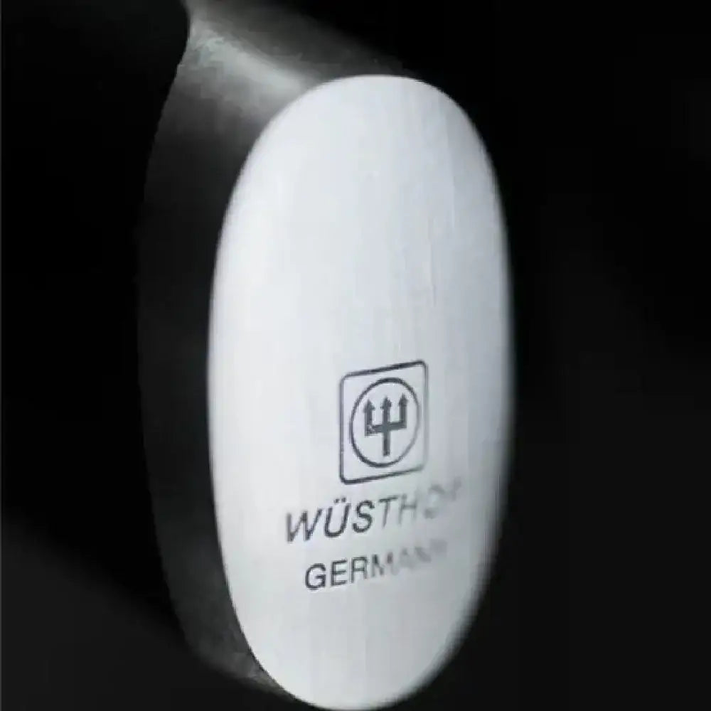 Close-up of a Wüsthof knife handle with brand logo on a black background