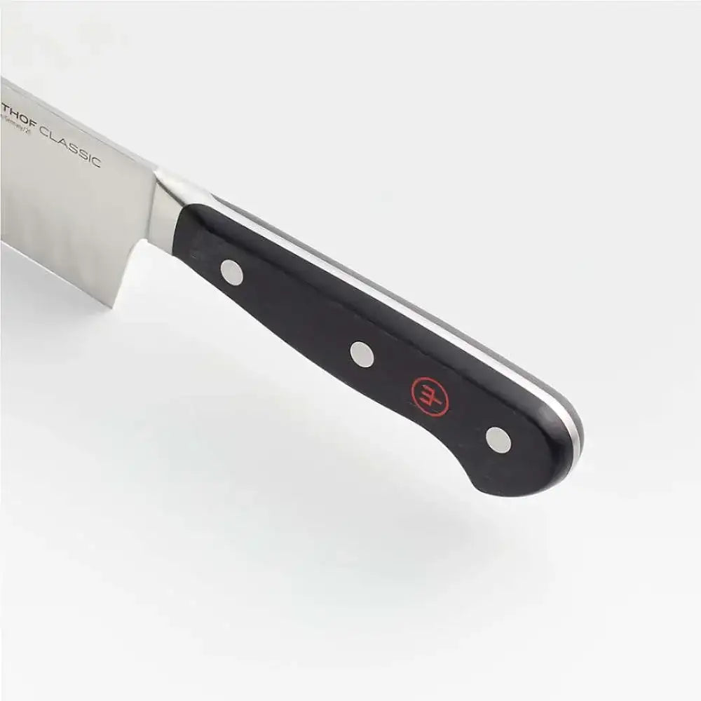 Knife with a black handle and silver blade on a white background