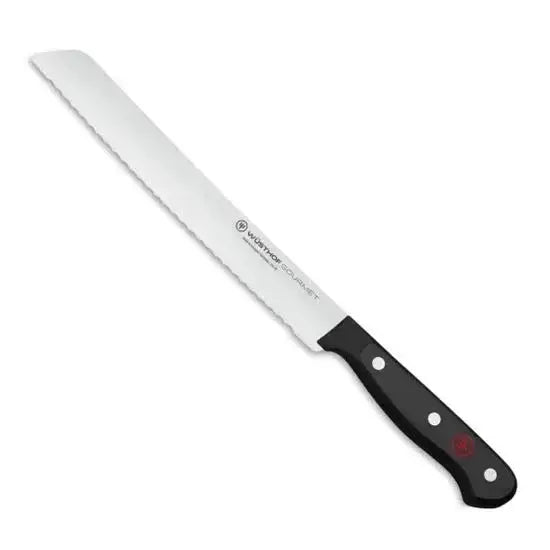 Bread knife with black handle on a white background