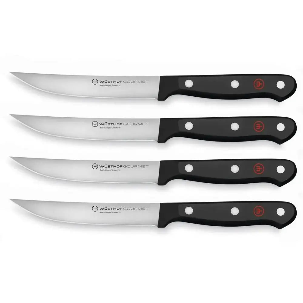 Set of five Wüsthof Gourmet steak knives on a white background