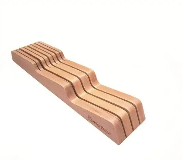 Set of Wusthof knives on a wooden block with a white background
