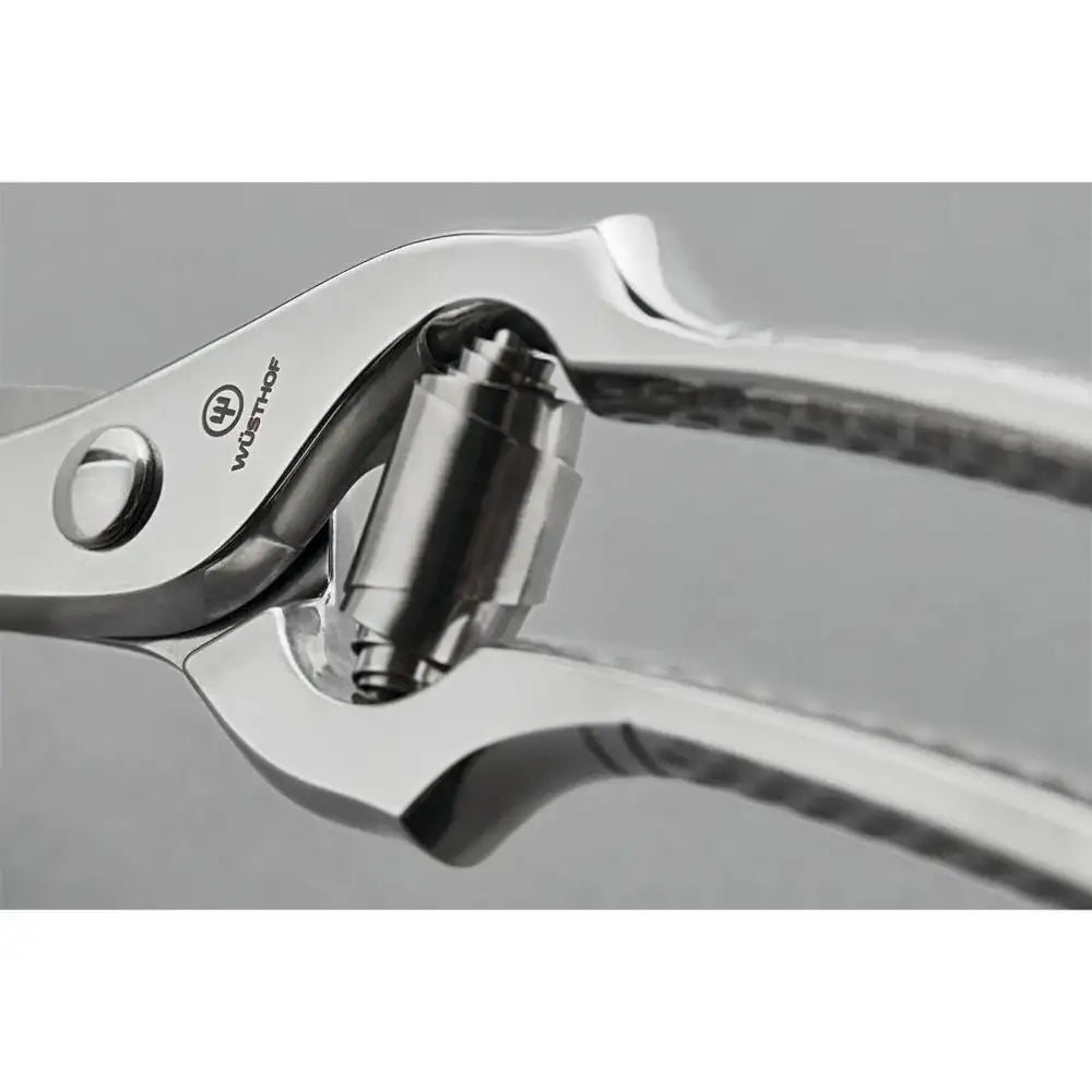Close-up of a pair of Wusthof kitchen shears on a gray background