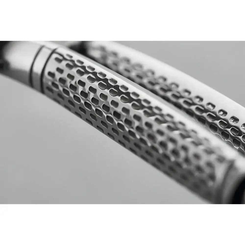 Close-up of a metallic object with a textured surface on a gray background