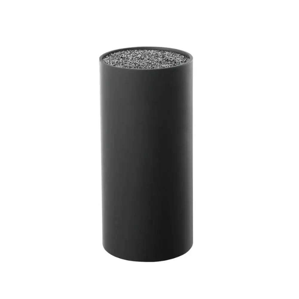 Black cylindrical object with textured top on a white background
