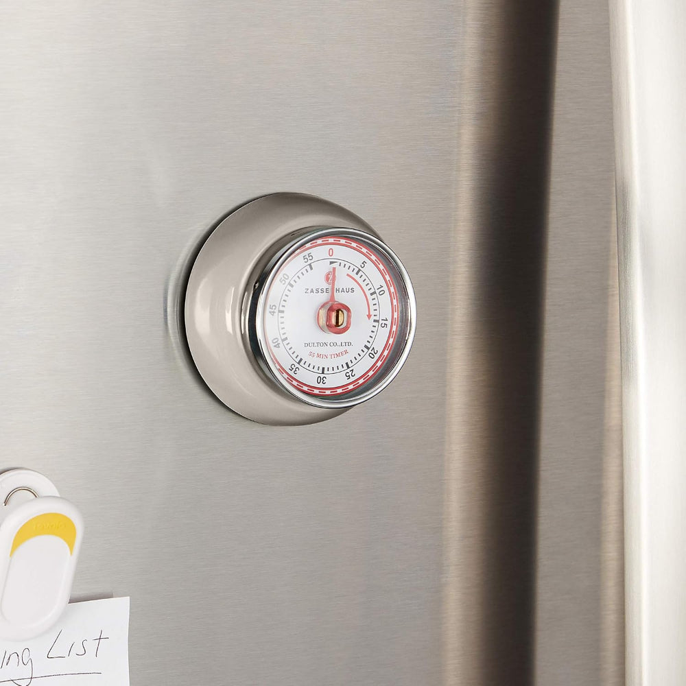 Magnetic timers on a refrigerator door with a visible brand name.