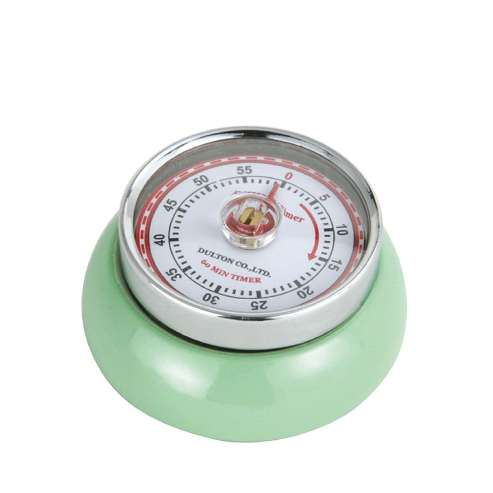 Green kitchen timer with a white face and red accents on a white background