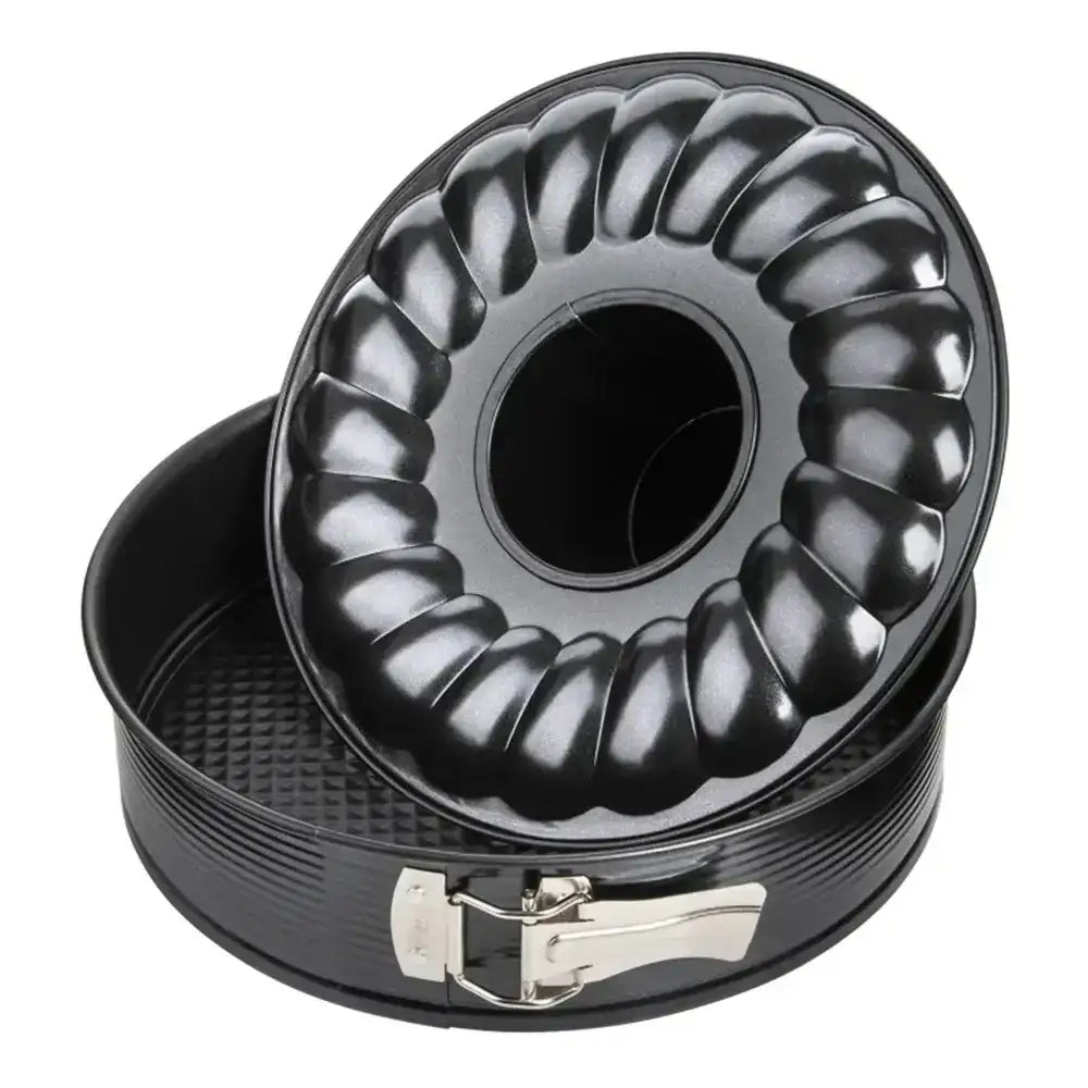 Black Bundt cake pan with ribbed design on a white background