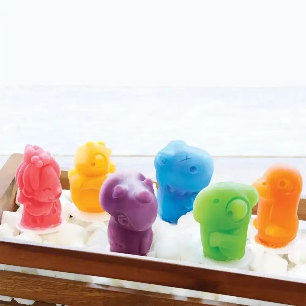 Colorful animal-shaped ice molds on a white surface with a light blue background