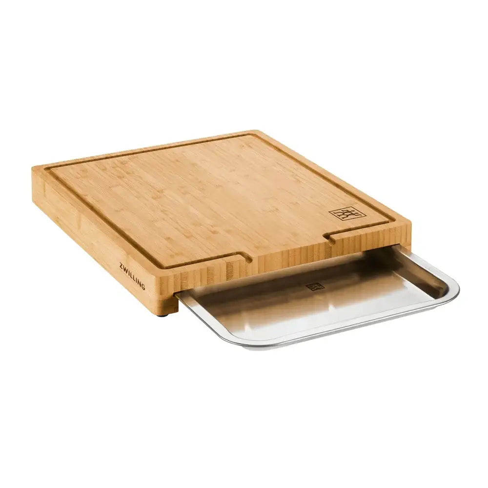 Wooden cutting board with a built-in tray on a white background