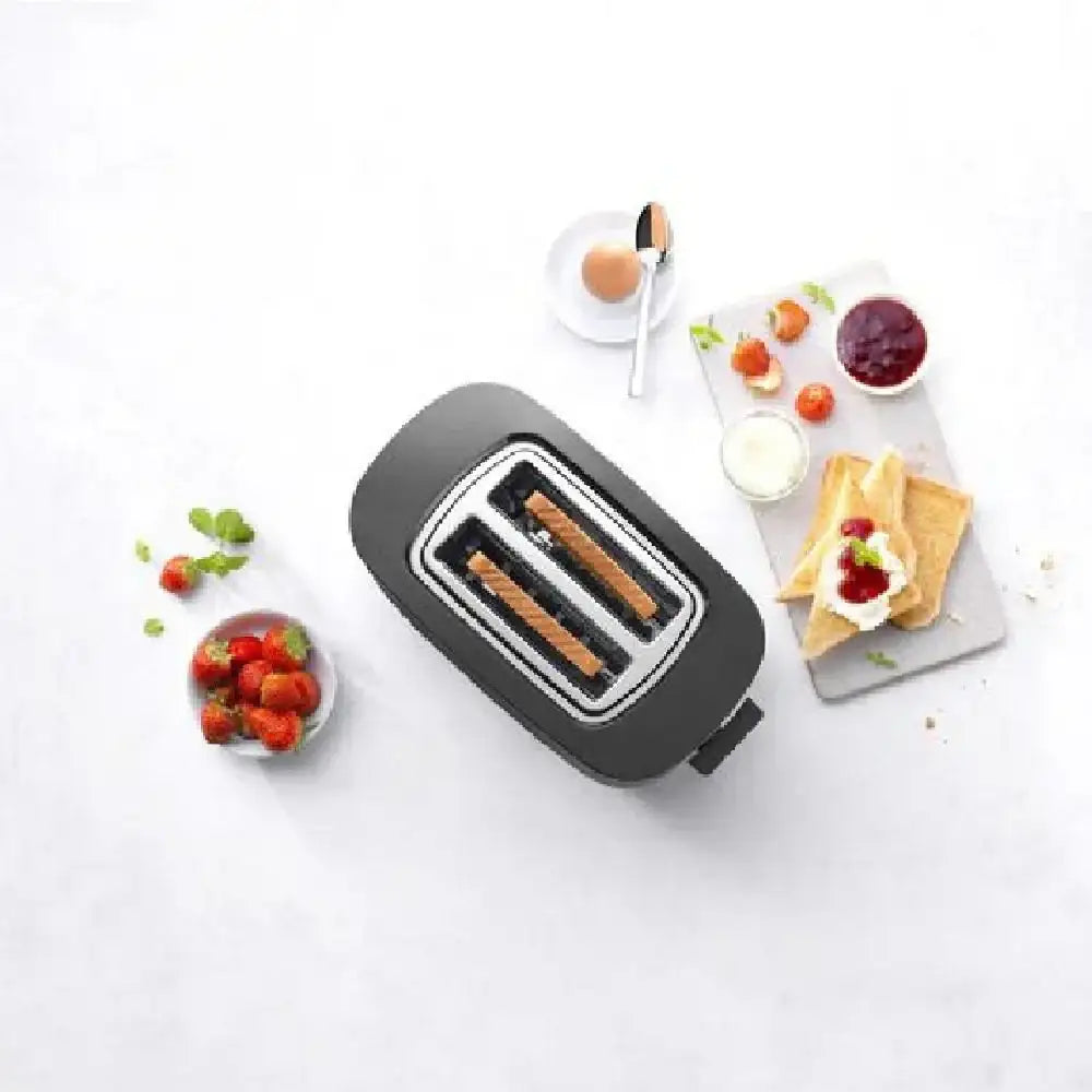 Black toaster with toast on a white surface with breakfast items around