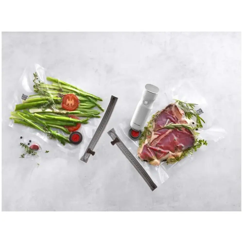 Vacuum sealer with food packaging on a white background