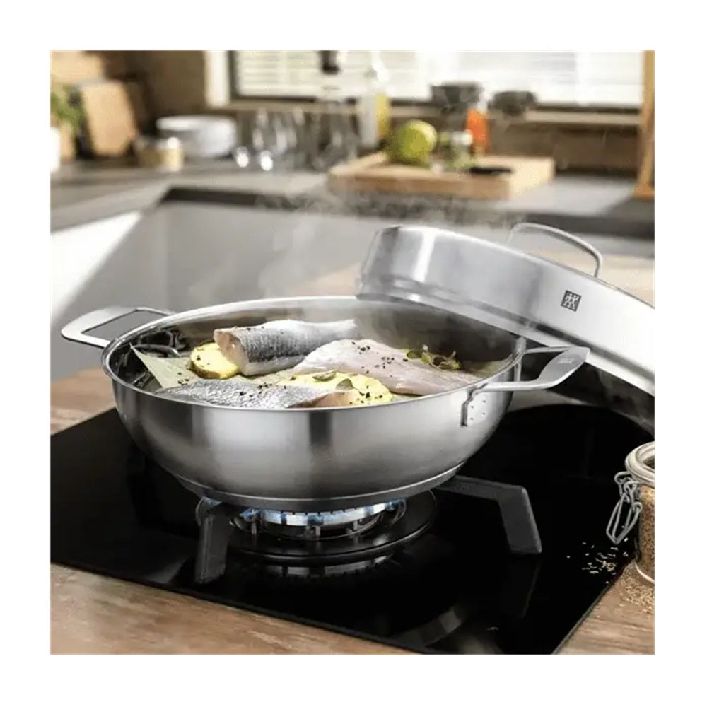 Stainless steel wok on a stove with food being cooked in a kitchen setting