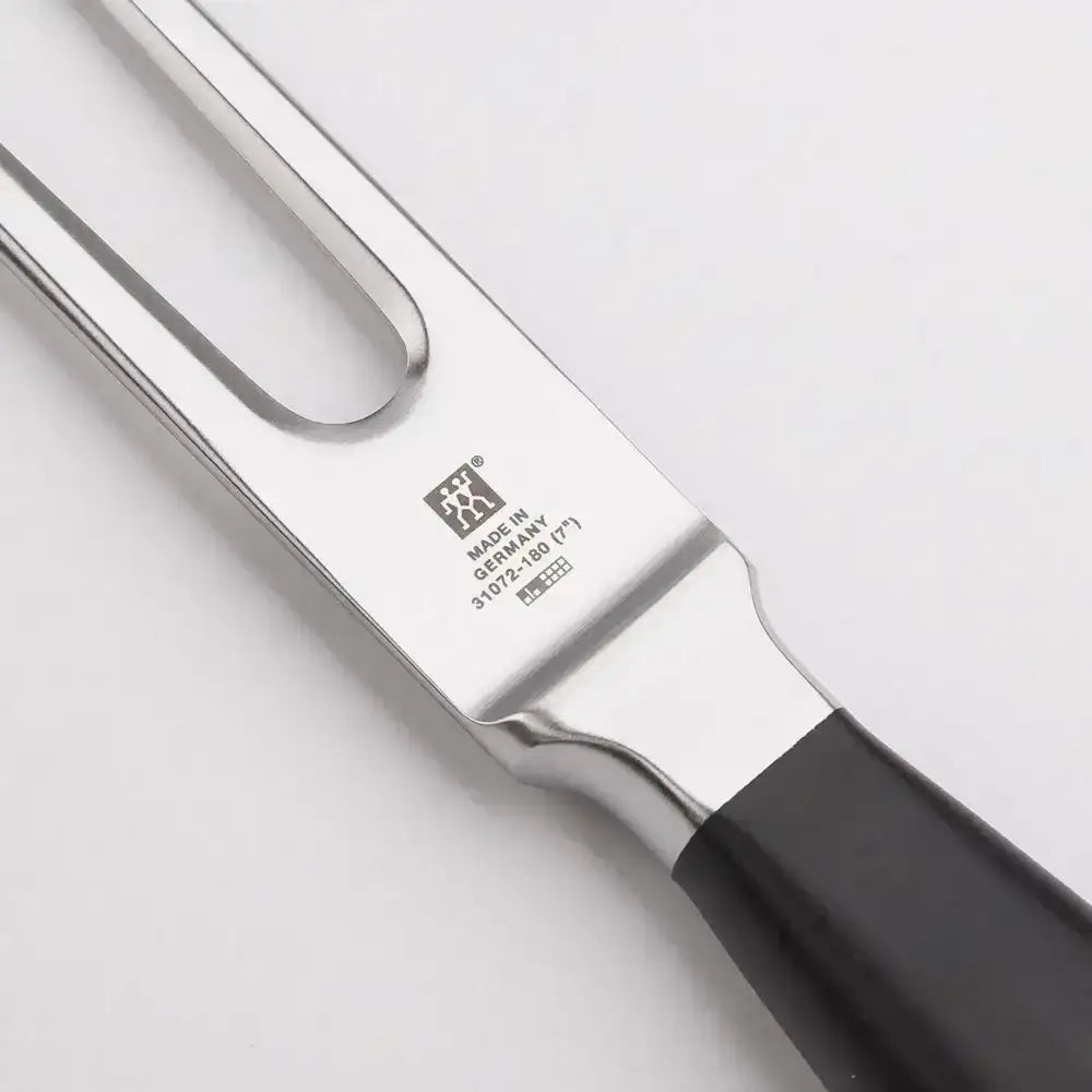 Knife with black handle and silver blade on a light gray background
