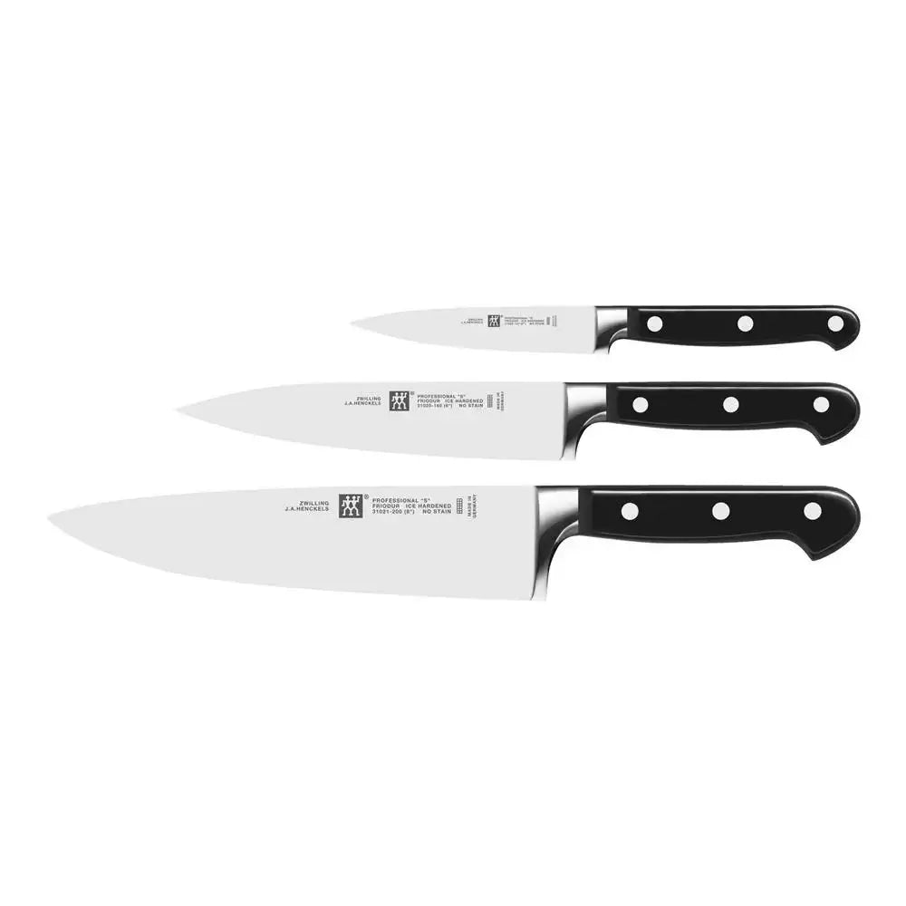 Set of four knives with black handles on a white background