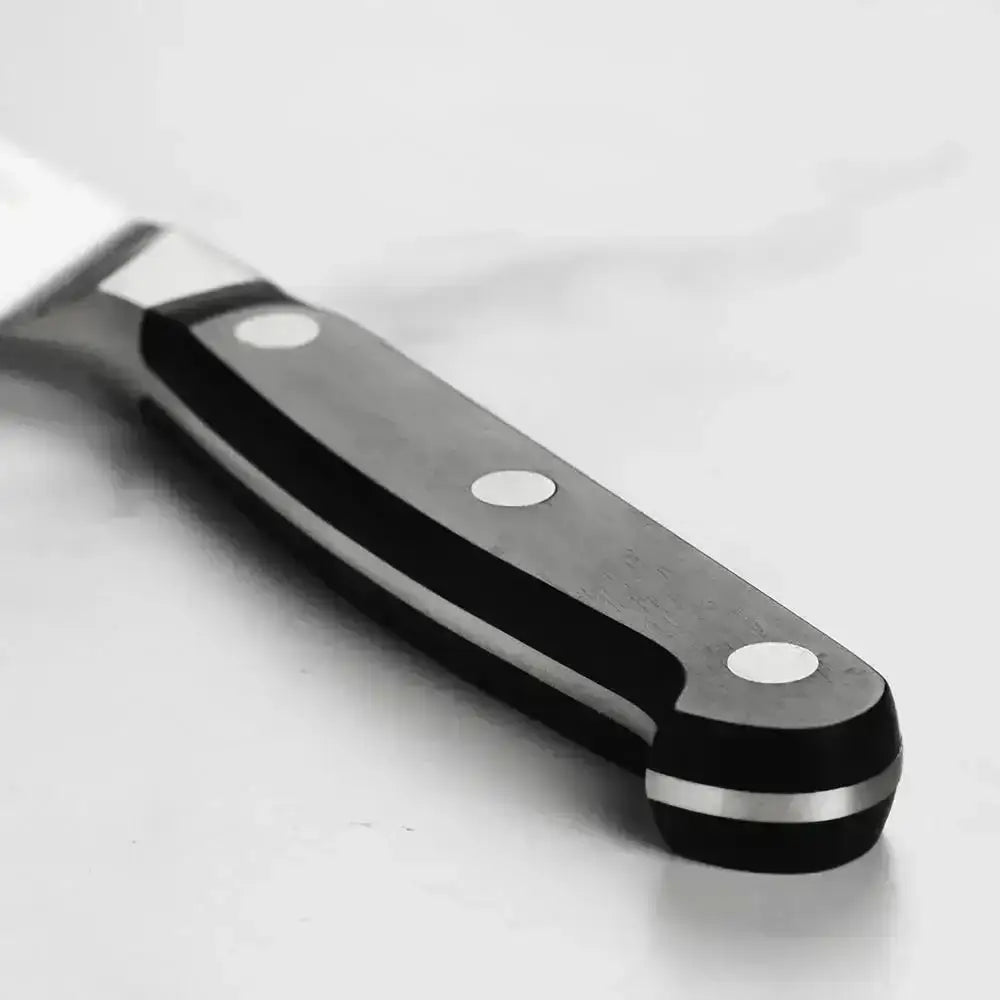 Close-up of a knife with a black handle on a white background