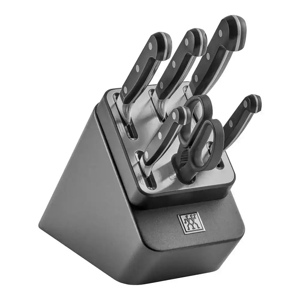 Set of knives in a black knife block on a white background