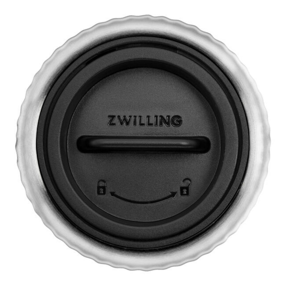 A close-up of a black and silver metal grinder cap with the brand name 'ZWILLING' embossed in the center, shown against a plain white background.