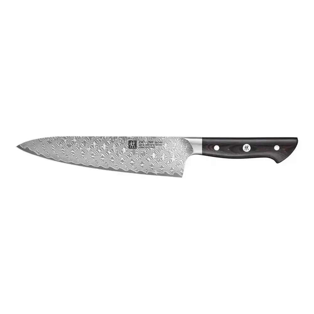 Chef's knife with a textured blade on a white background