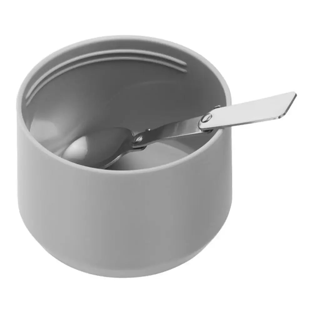 Gray ceramic bowl with a spoon on a white background