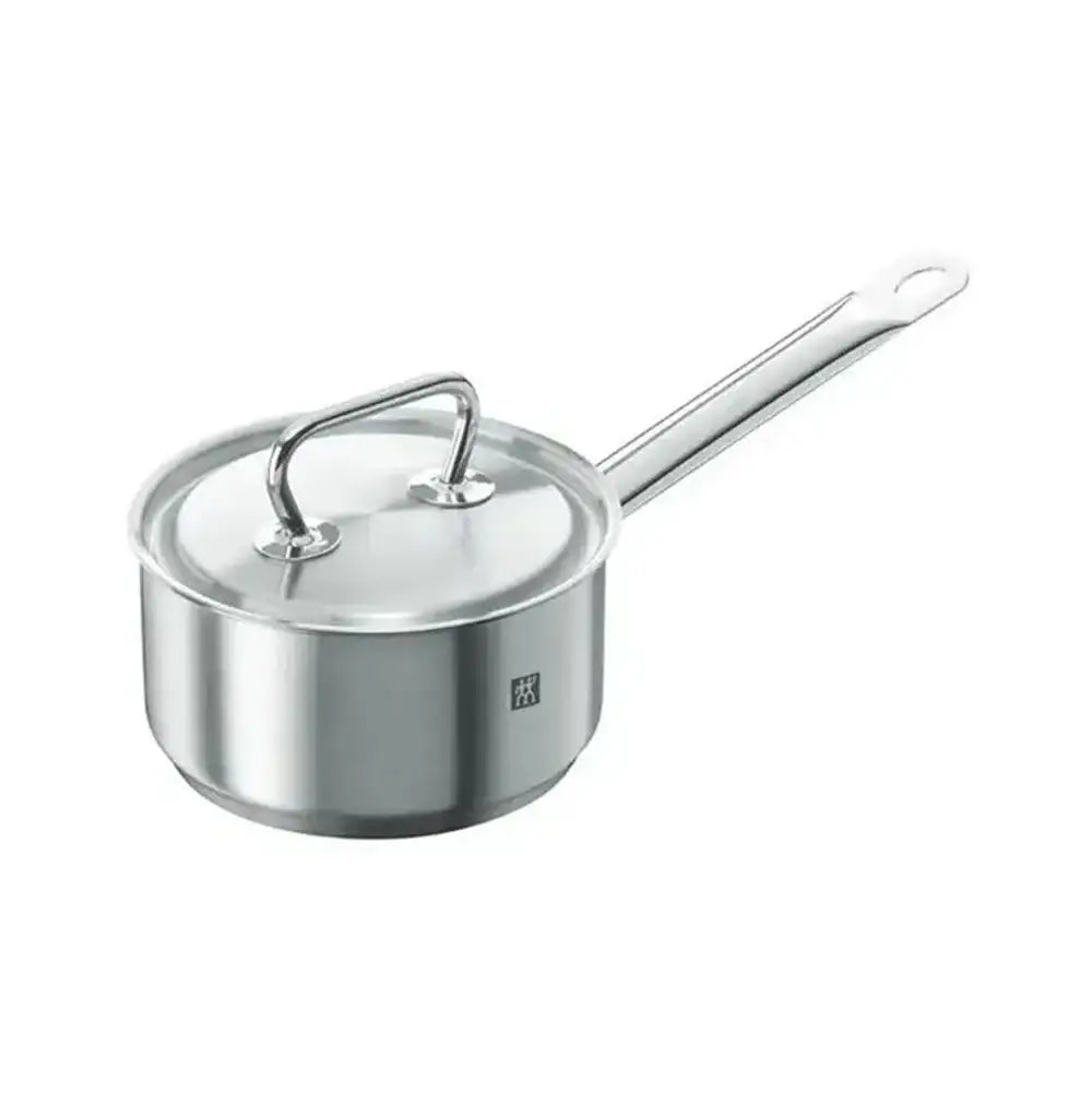 Stainless steel saucepan with lid on a white background