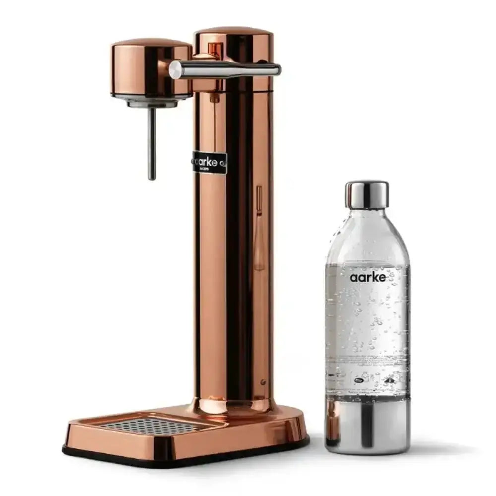 Copper water carbonator with matching bottle for sparkling water on white background