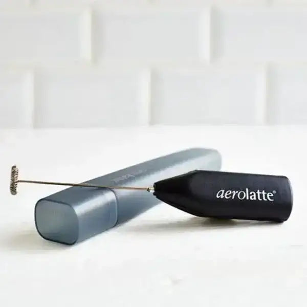 Metallic milk frother with black handle labeled 'aerolatte' on a white background