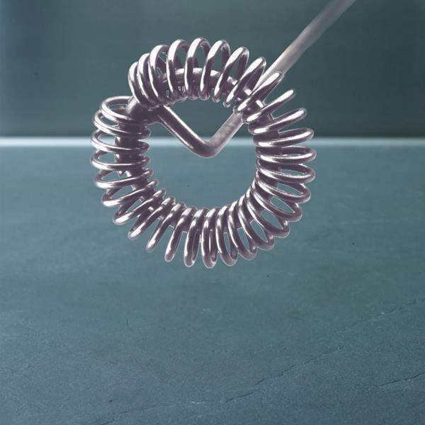 Silver coil spring on a dark green background