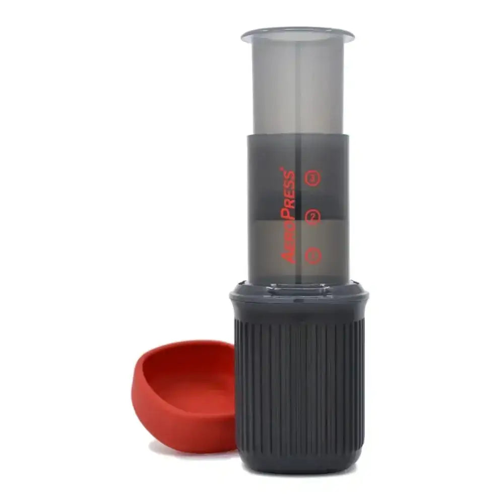 Black and red AeroPress coffee maker on a white background