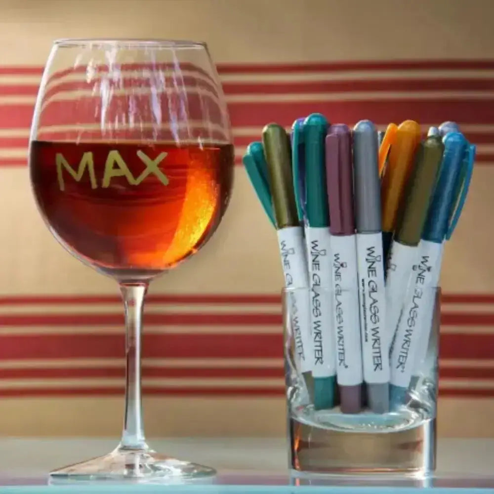 Wine glass with 'MAX' and a set of wine glass markers on a striped background