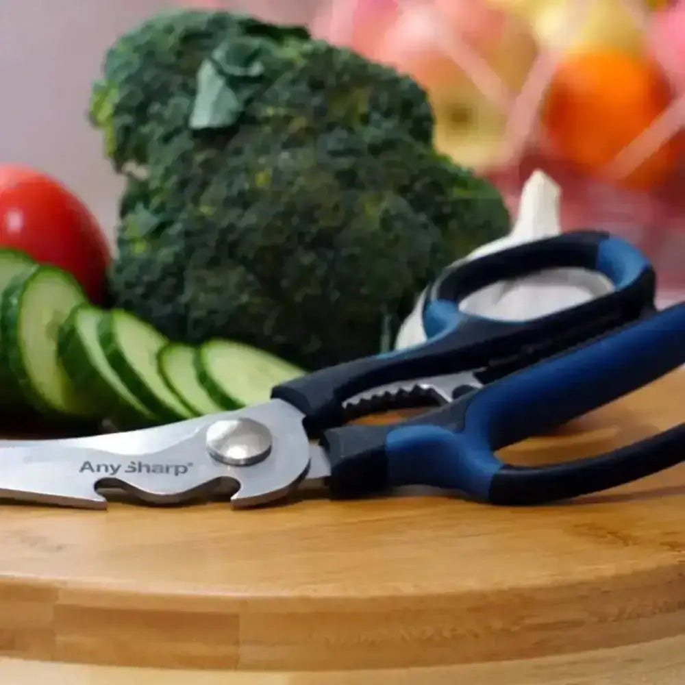 AnySharp kitchen shears on a wooden cutting board with vegetables in the background