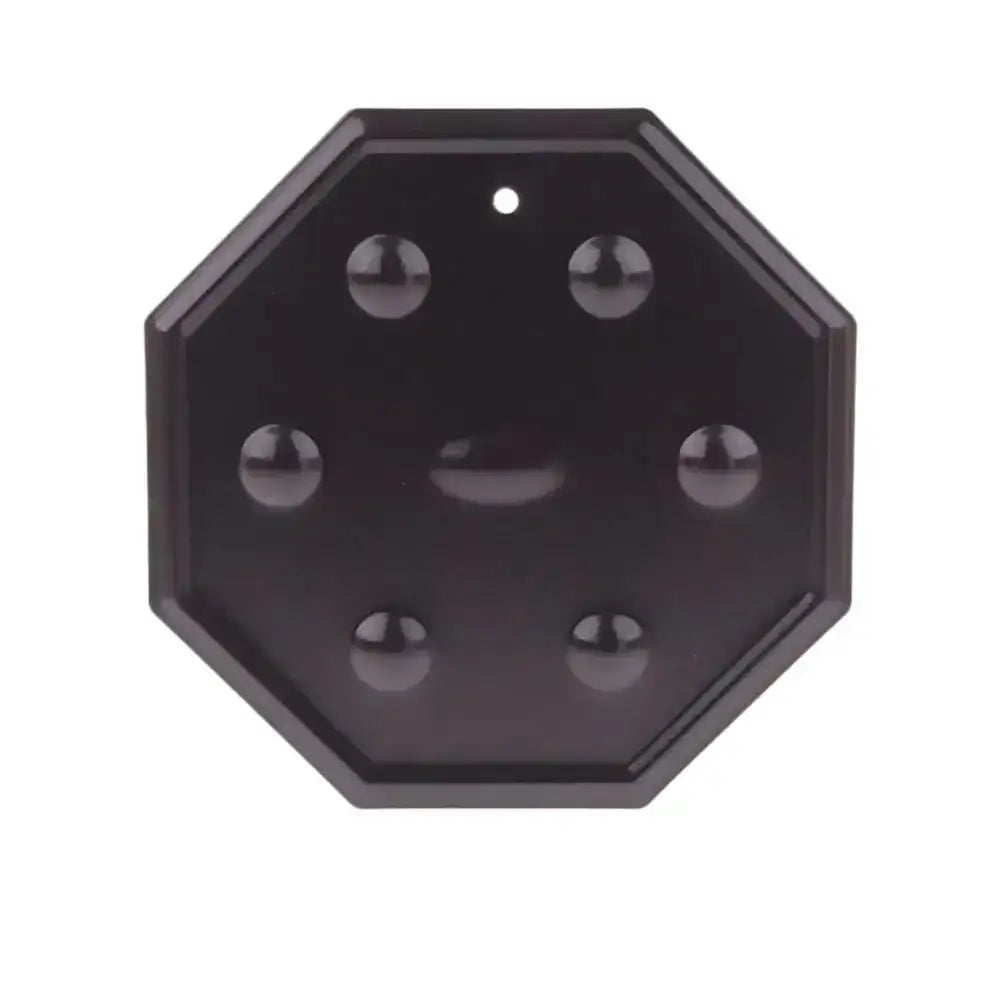 Black heat diffuser with multiple small spheres on a white background